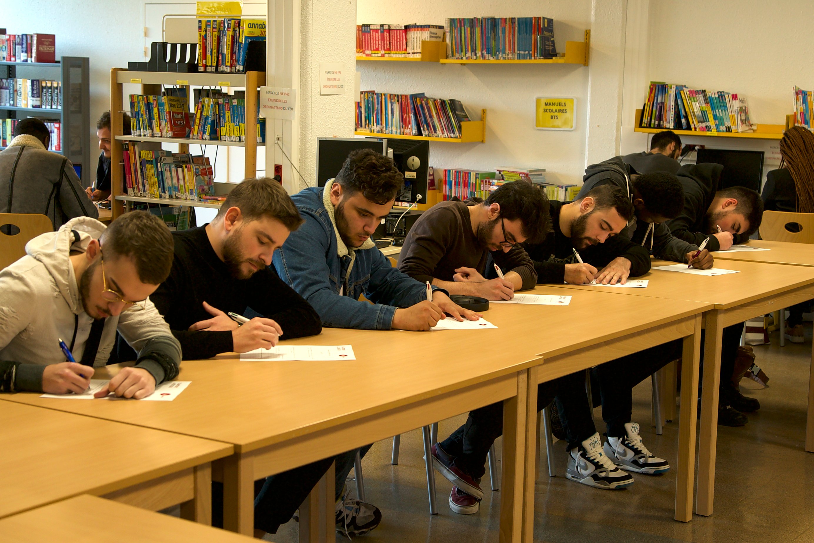 Students Writing In a Library